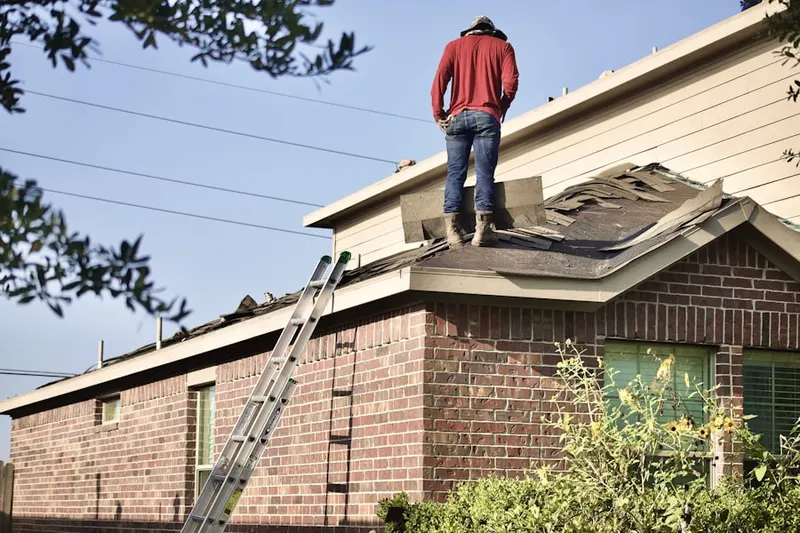 Professional roofer working on a residential roof in The Island at Ocotillo